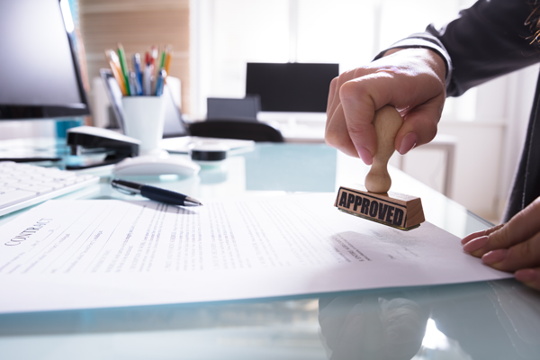 Business man stamping a document for FAA certification.